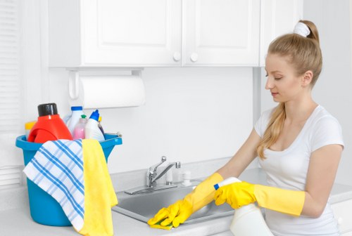 Technician inspecting and cleaning a lounge sofa in a W2 flat